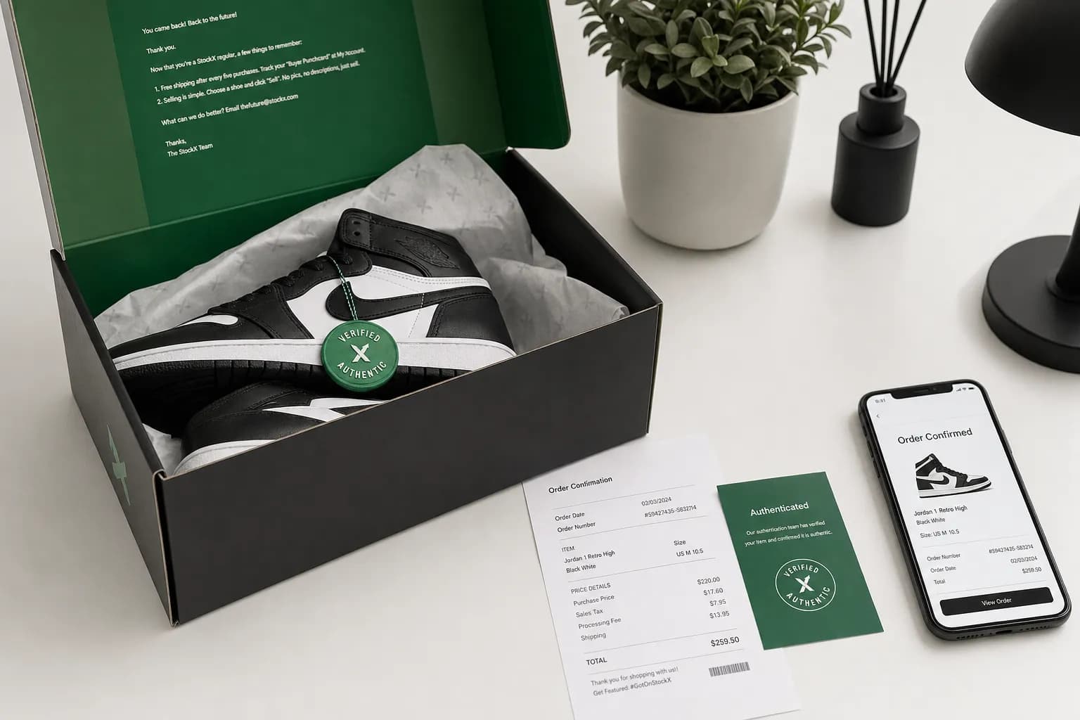 Premium sneakers in a StockX box with authentication tag and order confirmation receipt next to a smartphone